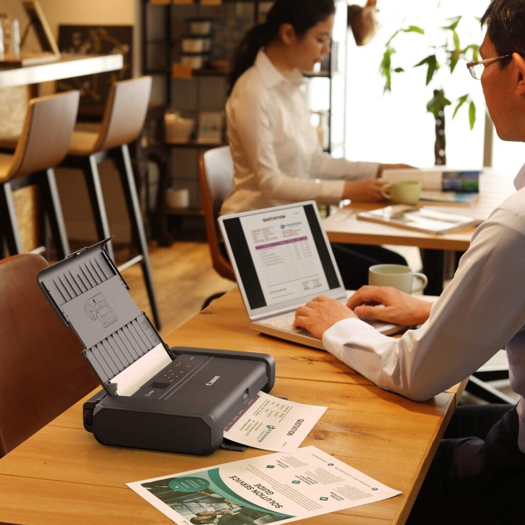 Canon PIXMA TR150 Wireless Mobile Color Printer being used in a coffee shop